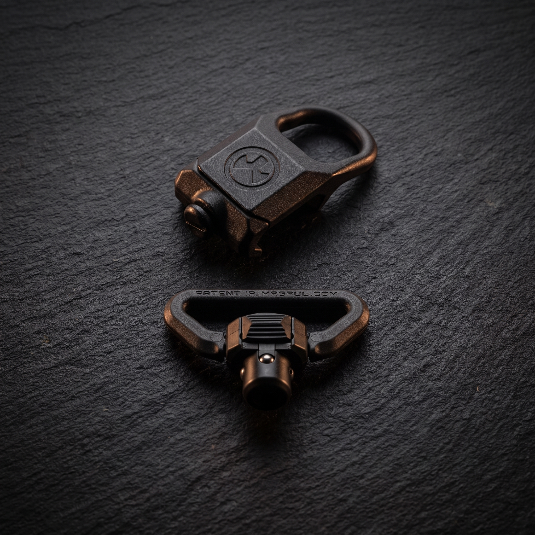 Magpul rail sling attachment and QD sling swivel in a flat lay, illustrating our guide to AR-15 upgrades under £100