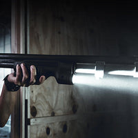 TL-Racker forend light fitted to a Mossberg pump-action shotgun in place of the factory forend