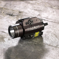 Streamlight TLR-2 G light and green laser in black photographed on a slate background